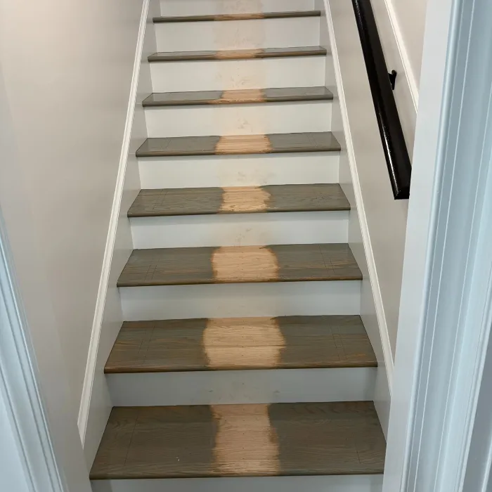 Worn hardwood stairs before stair runner